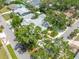 An overhead view showing mature trees and landscaping surrounding the property at 400 5Th S Ave, Safety Harbor, FL 34695