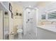 Clean bathroom featuring a shower with a white curtain and a black and white tiled floor at 400 5Th S Ave, Safety Harbor, FL 34695