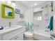 Bright bathroom features a tub and shower combo, complemented by a white vanity and decorative mirror at 400 5Th S Ave, Safety Harbor, FL 34695