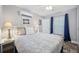 This cozy bedroom features a bed, window, end table, and a wall mounted air conditioner at 400 5Th S Ave, Safety Harbor, FL 34695