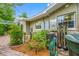 Exterior view showcasing the home's utilities and equipment surrounded by landscaping at 400 5Th S Ave, Safety Harbor, FL 34695