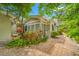 Home exterior featuring lush landscaping and a brick pathway leading to the entrance at 400 5Th S Ave, Safety Harbor, FL 34695