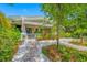 Charming home with a welcoming front porch, lush garden, and brick pathway at 400 5Th S Ave, Safety Harbor, FL 34695