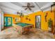Bright game room features a well-maintained pool table, travertine floors and fun decor at 400 5Th S Ave, Safety Harbor, FL 34695