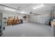 Spacious garage with epoxy flooring, overhead lighting, and ample storage for a functional workspace at 400 5Th S Ave, Safety Harbor, FL 34695