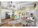 Open kitchen with stainless steel appliances, a central island, and travertine flooring adjacent to dining area at 400 5Th S Ave, Safety Harbor, FL 34695