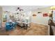 Bright living area with travertine tile, connecting seamlessly to the dining area and backyard at 400 5Th S Ave, Safety Harbor, FL 34695
