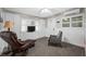 Comfortable living room with a recliner, tile floors, built-in cabinets, and bright natural light at 400 5Th S Ave, Safety Harbor, FL 34695