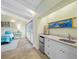 Mini bar area in main bedroom featuring white cabinets, travertine floors and tray-ceiling at 400 5Th S Ave, Safety Harbor, FL 34695