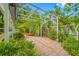 Paver patio area with open pergola and surrounding lush landscaping for outdoor relaxation at 400 5Th S Ave, Safety Harbor, FL 34695