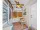 Cozy sunroom with natural light, ceiling fan, and dining set for relaxed indoor-outdoor living at 400 5Th S Ave, Safety Harbor, FL 34695
