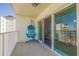 Private balcony with a unique hanging chair and sliding glass doors at 400 64Th Ave # 1108, St Pete Beach, FL 33706