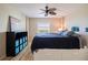 Inviting bedroom with light wood floors, a ceiling fan and a storage unit for organization at 400 64Th Ave # 1108, St Pete Beach, FL 33706