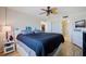 Cozy bedroom showcasing light wood flooring with connecting bathroom at 400 64Th Ave # 1108, St Pete Beach, FL 33706