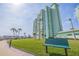 Beautiful view of a building with a large lawn, landscaping and benches at 400 64Th Ave # 1108, St Pete Beach, FL 33706