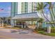 Exterior entrance featuring a guardhouse and well-maintained landscaping, offering a secure and welcoming access point at 400 64Th Ave # 1108, St Pete Beach, FL 33706
