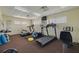 Community fitness center equipped with cardio machines, weights, and a television at 400 64Th Ave # 1108, St Pete Beach, FL 33706