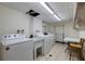 Functional laundry room featuring a washer, sink, and dryer with ample space for folding and sorting at 400 64Th Ave # 1108, St Pete Beach, FL 33706