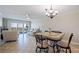 Bright living room with a tile floor, dining area, and a fantastic view of the city from the large windows at 400 64Th Ave # 1108, St Pete Beach, FL 33706