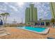Inviting pool with lounge chairs, umbrellas, views of the building and blue skies at 400 64Th Ave # 1108, St Pete Beach, FL 33706