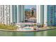 Aerial view of a sparkling pool area and shuffleboard courts in a beautiful waterfront setting at 400 64Th Ave # 1108, St Pete Beach, FL 33706