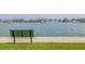 Relaxing waterfront view with bench seating overlooking the bay and nearby homes at 400 64Th Ave # 1108, St Pete Beach, FL 33706