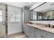 Bright bathroom featuring a double vanity with stylish countertops, framed mirror and natural light at 4390 6Th Isle Dr, Hernando Beach, FL 34607