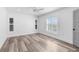 Bright, white bedroom with two shuttered windows and stylish hardwood floors at 4390 6Th Isle Dr, Hernando Beach, FL 34607