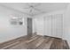 Bright bedroom with wood-look flooring, ceiling fan, and white trim at 4390 6Th Isle Dr, Hernando Beach, FL 34607