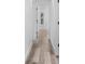 Light and bright hallway with wood-look flooring and white walls at 4390 6Th Isle Dr, Hernando Beach, FL 34607