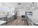 Open-concept kitchen features gray cabinets, an island, stainless steel refrigerator and modern lighting at 4390 6Th Isle Dr, Hernando Beach, FL 34607