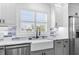 Close-up of bright farmhouse sink with modern faucet under bright shuttered window at 4390 6Th Isle Dr, Hernando Beach, FL 34607