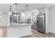 Modern kitchen featuring an island with granite countertops, stainless steel appliances, and pendant lighting at 4390 6Th Isle Dr, Hernando Beach, FL 34607