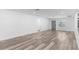 Bright, open-concept living room with modern wood-look floors, smooth white walls and natural light at 4390 6Th Isle Dr, Hernando Beach, FL 34607