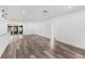 Bright, open-concept living room with modern wood-look floors, smooth white walls and patio access at 4390 6Th Isle Dr, Hernando Beach, FL 34607