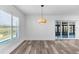 Bright living room with hardwood floors, shuttered windows, and sliding glass doors to enclosed patio at 4390 6Th Isle Dr, Hernando Beach, FL 34607