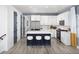 Modern kitchen features a center island with seating, stainless steel appliances, and white cabinets at 4717 W Mccoy St # 18, Tampa, FL 33616