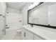 Bathroom featuring a shower-tub combo, large mirror and bright white vanity at 4717 W Mccoy St # 9, Tampa, FL 33616