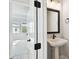 Bathroom featuring a pedestal sink, black hardware and view into the bedroom at 4717 W Mccoy St # 9, Tampa, FL 33616