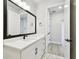 Bathroom with white vanity and marble tile flooring, leading to the doorway to another room at 4717 W Mccoy St # 9, Tampa, FL 33616
