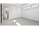 Bright bedroom with neutral carpet, white walls, tray ceiling, an open doorway and large windows at 4717 W Mccoy St # 9, Tampa, FL 33616