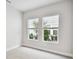Bedroom with two windows providing natural light and a neutral color palette at 4717 W Mccoy St # 9, Tampa, FL 33616