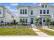 Charming two-story home with a well-manicured lawn, black fence, and a vibrant blue front door at 4717 W Mccoy St # 9, Tampa, FL 33616
