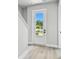 Bright foyer with a white front door with glass and light wood flooring at 4717 W Mccoy St # 9, Tampa, FL 33616