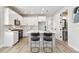 Modern kitchen features a center island with white cabinets and stainless steel appliances at 4717 W Mccoy St # 9, Tampa, FL 33616