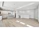 Open-concept living room with a kitchen, hardwood floors, white walls, and natural light at 4717 W Mccoy St # 9, Tampa, FL 33616