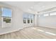 Spacious living room featuring modern windows with light wood flooring and plenty of natural light at 4717 W Mccoy St # 9, Tampa, FL 33616