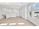 Bright living room with hardwood floors, white walls, and natural light streaming through the large windows at 4717 W Mccoy St # 9, Tampa, FL 33616