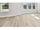Bright living room featuring wood floors, white walls, and natural light from double-hung windows at 4717 W Mccoy St # 9, Tampa, FL 33616