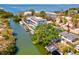 An aerial view of a waterfront home with a boat dock and lush landscaping on a sunny day at 4834 W Flamingo Rd, Tampa, FL 33611